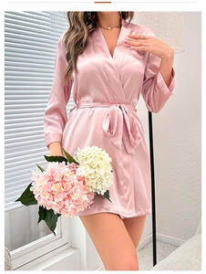 Detail of pink satin bathrobe with V-neckline, silk tie belt and elegant long sleeves