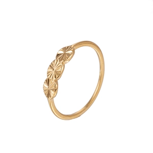 Detailed view of narrow gold metal ring featuring three round sunburst engraved ornaments