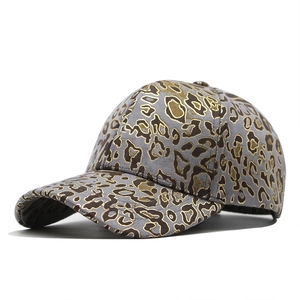 Detail of grey baseball cap with golden leopard print and six-panel stitch design