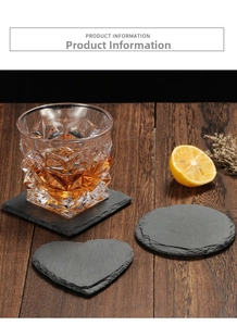 Detail of square, round, and heart natural black slate coasters on dark wood table