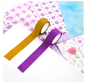 Close-up of sparkling gold and purple glitter washi tape for DIY journal scrapbooking