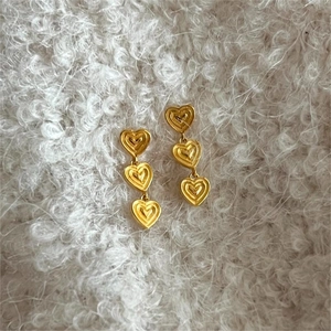 Elegant gold-plated 925 sterling silver triple heart stud earrings on white plush background