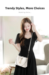 Chic cream bucket bag with lychee texture and gold chain strap on a black dress