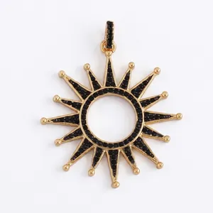 Macro shot of sunburst pendant with gold plating and pavé set black stones