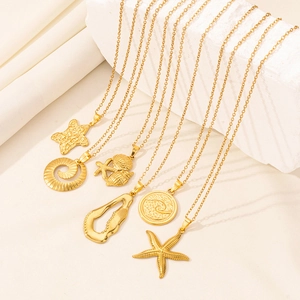 Detailed display of gold starfish and seashell necklaces on textured stone background