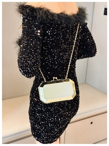 Detail of octagonal mirror evening clutch with gold metal frame and elegant chain strap