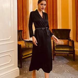 Detail of elegant black silk satin loungewear robe with V-neckline and matching waist belt