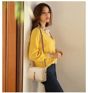 Chic apricot shell crossbody bag in lychee pattern leather shown on model's shoulder