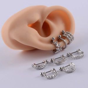 Zirconia studded stainless steel ear cuffs shown on a silicone ear model in silver finish