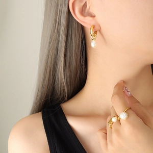 Baroque pearl C-shape earrings and ring set in gold finish on female model
