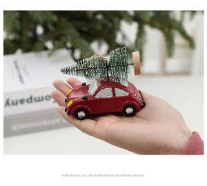 Close-up of a resin miniature red vintage car with a frosted Christmas tree ornament