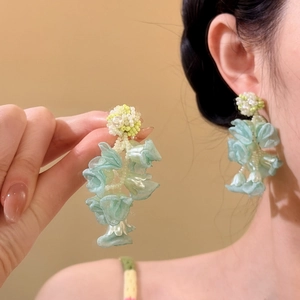 Detail of mint green organza flower tassel earrings for beach vacation style.