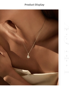 Detail of pear-cut moissanite pendant necklace with halo stones on a fine gold chain