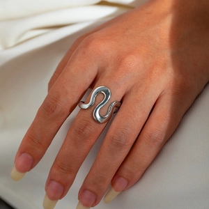 Detailed close-up of a silver irregular wave-shaped adjustable stainless steel ring