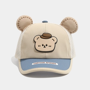 Detail of baby sun hat with cute bear ears, breathable mesh back and cartoon patch