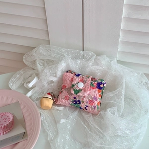 Pink floral quilted wallet detail with cupcake keychain and snap button closure