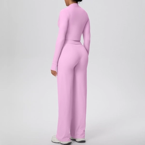 Detailed back view of pink yoga set with cropped long sleeve top and wide leg pants