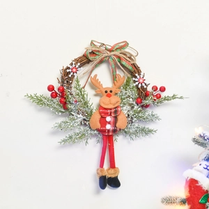 Detail of Christmas wreath featuring a plush reindeer, red berries, and pine needles
