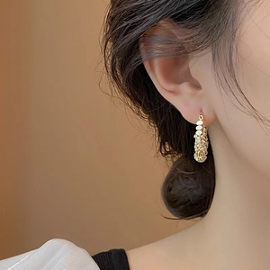 Golden textured geometric hoop earrings for women with minimalist metallic finish