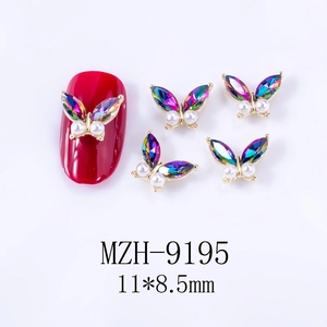 Detailed view of Aurora butterfly nail art charms with iridescent rhinestones and pearls