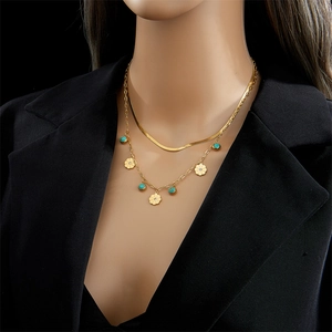 Double-layered gold snake chain necklace with turquoise beads and flower pendants