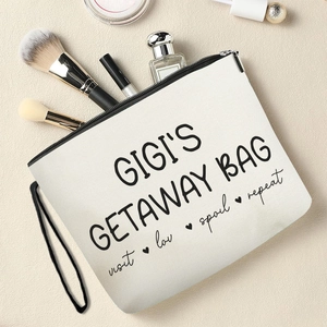 Gigi's Getaway Bag canvas makeup pouch with zipper and black print on beige surface