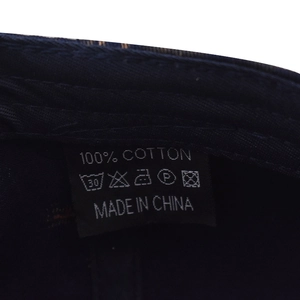 Detail of the 100% cotton washing label on vintage washed denim baseball cap