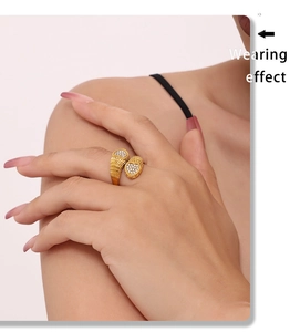 Wearing effect of golden double heart ring with inlaid sparkling zircons on finger