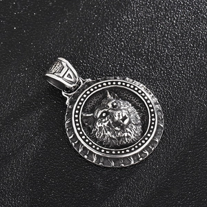 Macro shot of retro stainless steel wolf head pendant with vintage distressed finish