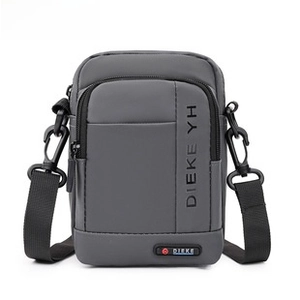 Detail view of water-resistant gray crossbody bag with textured fabric and zipper detail