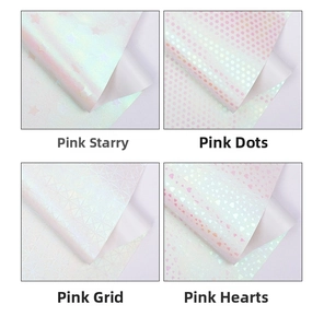 Detail view of pink glitter wrapping paper with star, dot, grid and heart patterns