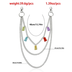 Detail showing colorful gummy bear charms on multi-layer metal pants chain with size labels