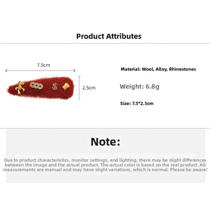 Detailed view of red wool pony hair clip with coin charms measuring 7.5x2.5cm
