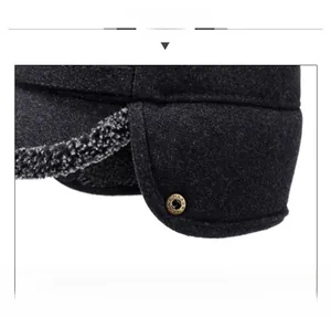 Detail of dark grey winter hat featuring thick faux fur lining and vintage metal buckle