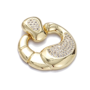 Close-up of gold croissant pendant featuring sparkling pavé cubic zirconia accents