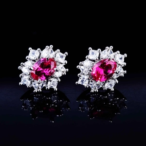 Luxury silver flower earrings with red oval gemstones and white diamond accents