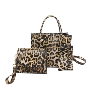 Three-piece leopard print bag set including tote, clutch, and purse in brown PU leather