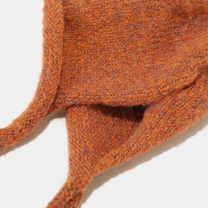 Macro shot of thick braided knit strap on winter hat with fuzzy blend texture