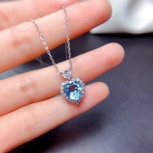 Exquisite silver necklace featuring a heart-shaped sky blue gemstone and halo diamonds