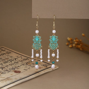 Detail of Chinese style butterfly tassel earrings with pearls and green enamel drops