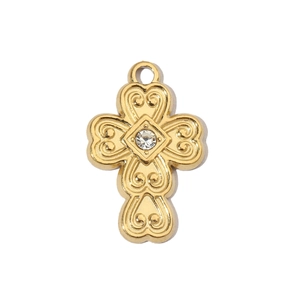 Detail of a vintage golden stainless steel cross pendant with heart edges and rhinestone