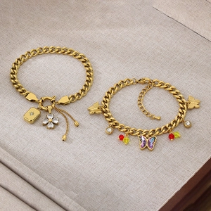 Detail of gold NK link chains featuring crystal flowers and purple gradient butterflies