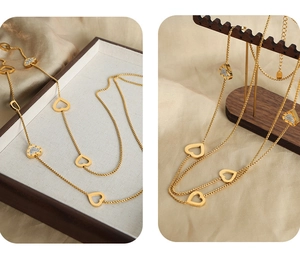 Detail of gold-plated double-layer heart sweater necklace with sparkling zircons