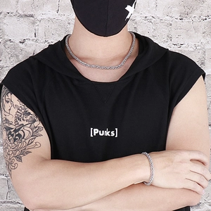 Close-up of stainless steel lantern link necklace worn by a model in streetwear style