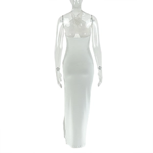 Detail view of the backless cutout design and high slit on a white maxi dress