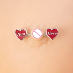 Detailed close-up of stainless steel heart nipple rings with red enamel and white letters