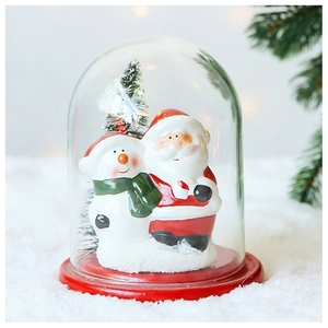 Detail of Christmas glass dome with Santa, snowman and mini tree on red base
