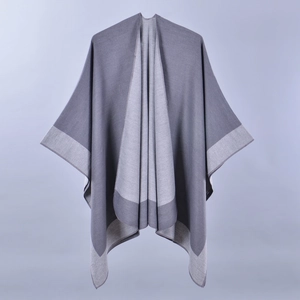 Detail of grey and light grey two-tone knit shawl poncho with professional split drape