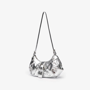 Detail of silver metallic shoulder bag with pleated design and decorative rivets