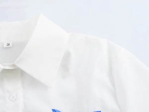 Close-up of white shirt collar with sharp stitching and S size label detail
